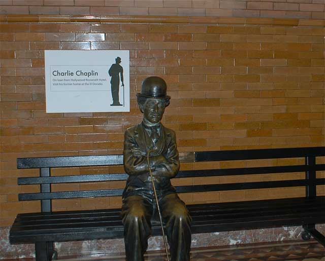 Excerpt from The Black Box
(Photo by Wendy Werris)
Jackson was quiet as they moved through the lobby and then turned left into the dimly lit side exit lobby. There was a bench there with a bronze statue of Charlie Chaplin sitting on it. Jackson sat down next to the figure and signaled Bosch to the other side. Charlie Chaplin bench