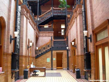 Excerpts From Angels Flight
The Bradbury was the dusty jewel of downtown. Built more than a century before, its beauty was old but still brighter and more enduring than any of the glass-and-marble towers that dwarfed it like a phalanx of brutish guards surrounding a beautiful child. Its ornate lines and glazed tile surfaces had withstood the betrayal of both man and nature. It had survived earthquakes and riots, periods of abandonment and decay, and a city that often didn't bother to safeguard what little culture and roots it had. Bosch believed there wasn't a more beautiful structure in the city — despite the reasons he had been inside it over the years.
To Bosch, the IAD was the only blemish on the building's beauty. Twice he had faced Board of Rights hearings in the Bradbury. Each time he gave his testimony, listened to witnesses and an IAD investigator — once it had been Chastain — report the facts and findings of the case, and then paced the floor beneath the atrium's huge glass skylight while the three captains privately decided his fate. He had come out okay after both hearings and in the process had come to love the Bradbury with its Mexican tile floors, wrought-iron filigree and suspended mail chutes. He had once taken the time to look up its history at the Los Angeles Conservancy offices, and found one of the more intriguing mysteries of Los Angeles: the Bradbury, for all its lasting glory, had been designed by a $5-a-week draftsman. George Wyman had no degree in architecture and no prior credits as a designer when he drew the plans for the building in 1892, yet his design would see fruition in a structure that would last more than a century and cause generations of architects to marvel. To add to the mystery, Wyman never again designed a building of any significance, in Los Angeles or anywhere else. The Bradbury Building