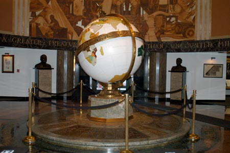 Excerpt From The Scarecrow (Photo by Wendy Werris)
The globe lobby was the formal entrance to the newspaper building at the corner of First and Spring. A brass globe the size of a Volkswagen rotated on a steel axis at the center of the room. The many international bureaus and outposts of the Times were permanently notched on the raised continents, despite the fact that many had been shuttered to save money. The marble walls were adorned with photos and plaques denoting the many milestones in the history of the paper, the Pulitzer Prizes won and the staffs that won them, and the correspondents killed in the line of duty. It was a proud museum, just as the whole paper would be before too long. The word was that the building was up for sale.
But I only cared about the next twelve days. I had one last deadline and one last murder story to write. I just needed that globe to keep turning until then. The Globe Lobby of the Los Angeles Times
