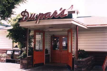 Excerpt From A Darkness More Than Night (Photo by Wendy Werris)
He walked into Du-par's, the corner restaurant in the market, but didn't see Winston at any of the tables or the counter. He hoped she hadn't come and gone. He chose an unoccupied booth that afforded the most privacy and sat down. He didn't need to look at the menu. They had chosen the Farmer's Market to meet because it was near Edward Gunn's apartment and because McCaleb wanted to eat breakfast at Du-par's. He had told Winston that more than anything else about Los Angeles, he missed the pancakes at Du-par's. Often when he and Graciela and the children made their once-a-month trip to overland to buy clothing and supplies not available on Catalina they ate a meal at Du-par's. It didn't matter whether it was breakfast, lunch or dinner, McCaleb always ordered pancakes. Raymond did, too. But he was boysenberry while McCaleb was traditional maple. Du-pars Restaurant