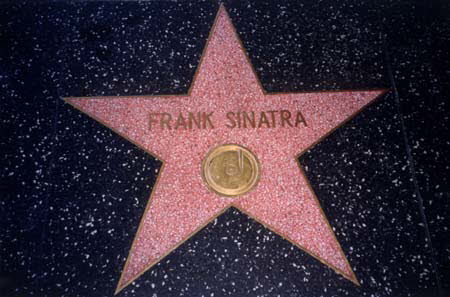 Excerpt From Angels Flight
In the long run, Frank Sinatra got ripped off. Decades ago, when the Hollywood Chamber of Commerce put his star down on the sidewalk, they put it on Vine Street rather than on Hollywood Boulevard. The thinking probably was that the Sinatra star would be a draw, people would come down from the Boulevard to see it, to take a picture. But if that was the plan, it didn't work. Frank was alone in a spot that probably saw more hypes than tourists. His star was at a crosswalk between two parking lots and next to a residence hotel where you had to convince the security guard to unlock the lobby door if you wanted to go in. Frank Sinatra's Star