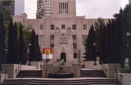Excerpt From Lost Light (Photo by Wendy Werris)
The downtown library was on Flower and Figueroa. It was one of the oldest buildings in the whole city. Therefore it was dwarfed by the modern glass-and-steel structures that surrounded it. Inside it was a beauty, centered around a domed rotunda with 360-degree mosaics depicting the founding of the city by the padres. The place had been twice burned by arsonists and closed for years, then restored to its original beauty. I had come after the restoration was completed, the first time back since I was a child. And I continued to come. It brought me close to the Los Angeles I remembered. Where I felt comfortable. I would take my lunch in the book rooms or the upper-level patios while reading case files and writing notes. I got to know the security guards and a few of the librarians. I had a library card, though I rarely checked out a book. Downtown Library